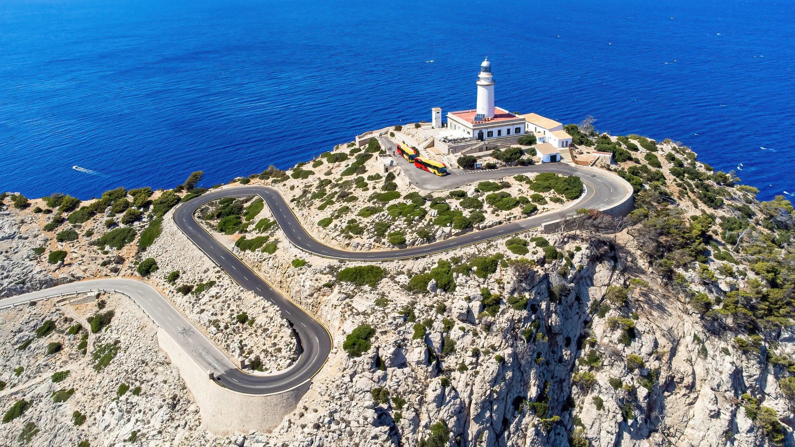 Aerial view of the lighthouse of Cape Formentor and of the hairpin road leading to it on the northeastern coast of Majorca in the Balearic Islands, Mediterranean Sea, Spain